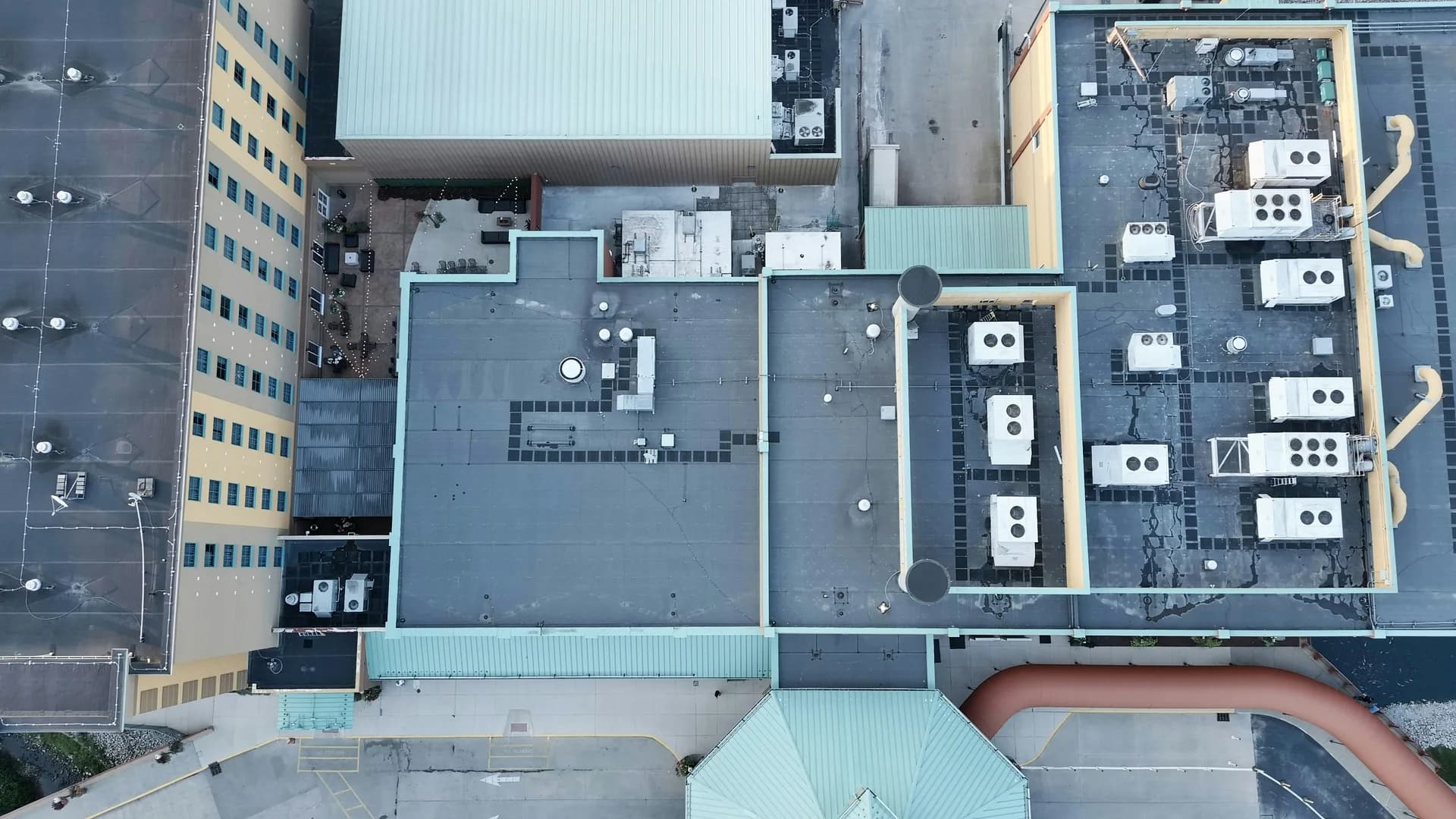 Aerial view of urban building rooftops with HVAC equipment and industrial installations